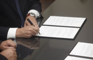 close up of businessman hands signing contract.jpeg